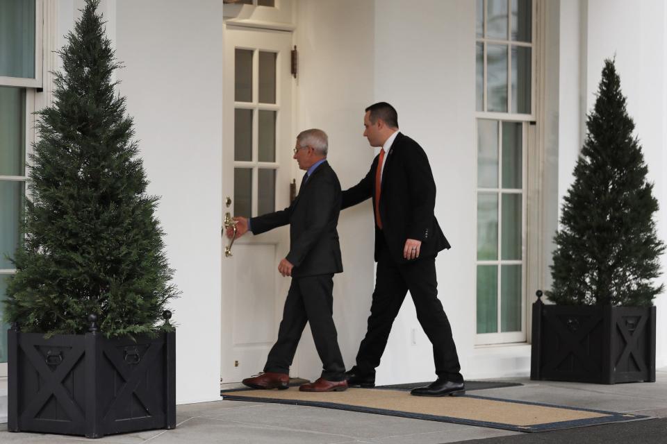 anthony fauci being escorted into the white house by one secret service agent