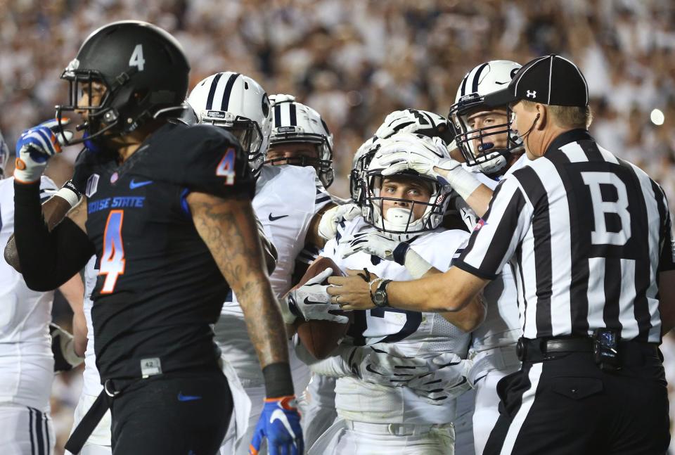 BYU receiver Mitchell Juergens is swarmed by teammates after catching the go-ahead touchdown as BYU and Boise State play Saturday, Sept. 12, 2015, at LaVell Edwards Stadium in Provo. | Scott G Winterton, Deseret News