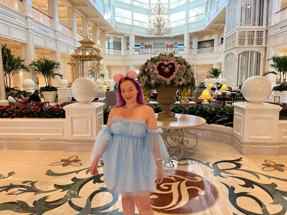 jenna posing for a photo in the lobby of the grand floridian resort