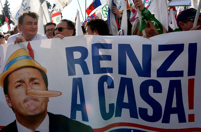 People hold a banner reading "Renzi go home!" as they take part in a rally held by Northern League party leader Matteo Salvini in Rome, on February 28, 2015