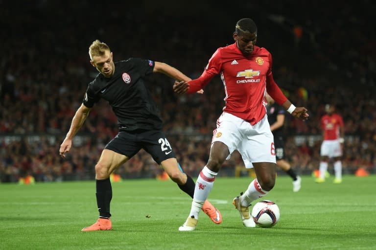 Zorya's Ukrainian midfielder Dmytro Grechyshkin (L) vies with Manchester United's French midfielder Paul Pogba during the UEFA Europa League group A football match between Manchester United and Zorya Luhansk