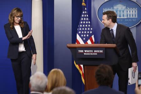 White House Press Secretary Josh Earnest (R) and actress Allison Janney, who played a fictional press secretary in "The West Wing" television show, stand together at the lectern before the daily press briefing at the White House in Washington, U.S., April 29, 2016. REUTERS/Jonathan Ernst