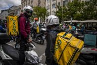 Delivery workers protest in front of the Spanish Parliament in Madrid, Spain, Tuesday, May 11, 2021. Spain has approved a pioneering law that gives delivery platforms a mid-August deadline to hire the workers currently freelancing for them and that requires transparency of artificial intelligence to manage workforces. (AP Photo/Manu Fernandez)