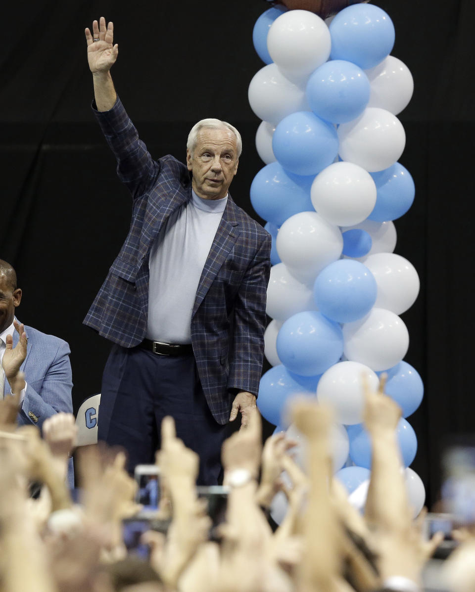 Coach Roy Williams waves as North Carolina basketball players and coaches greet fans in Chapel Hill, N.C., Tuesday, April 4, 2017 following Monday's win over Gonzaga in the NCAA college basketball championship. (AP Photo/Gerry Broome)
