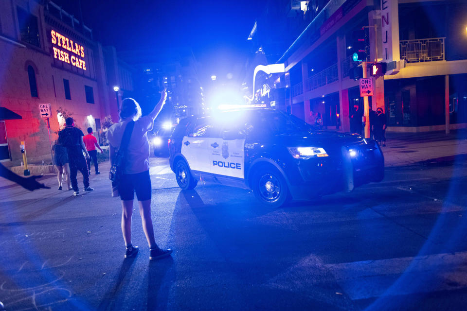 Protesters clash with police after a vigil held for Winston Boogie Smith Jr. early on Saturday, June 5, 2021. Authorities say Smith, wanted on a weapons violation, fired a gun from inside his vehicle before he was fatally shot by members of a federal task force as they were trying to arrest him. (AP Photo/Christian Monterrosa)