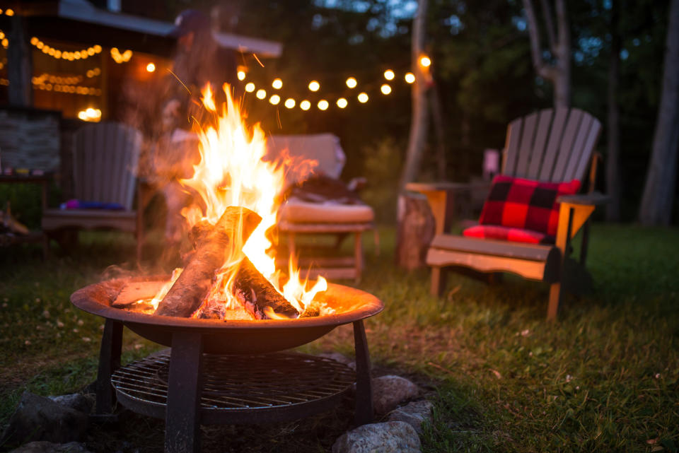 bonfire with adirondack chairs and blankets