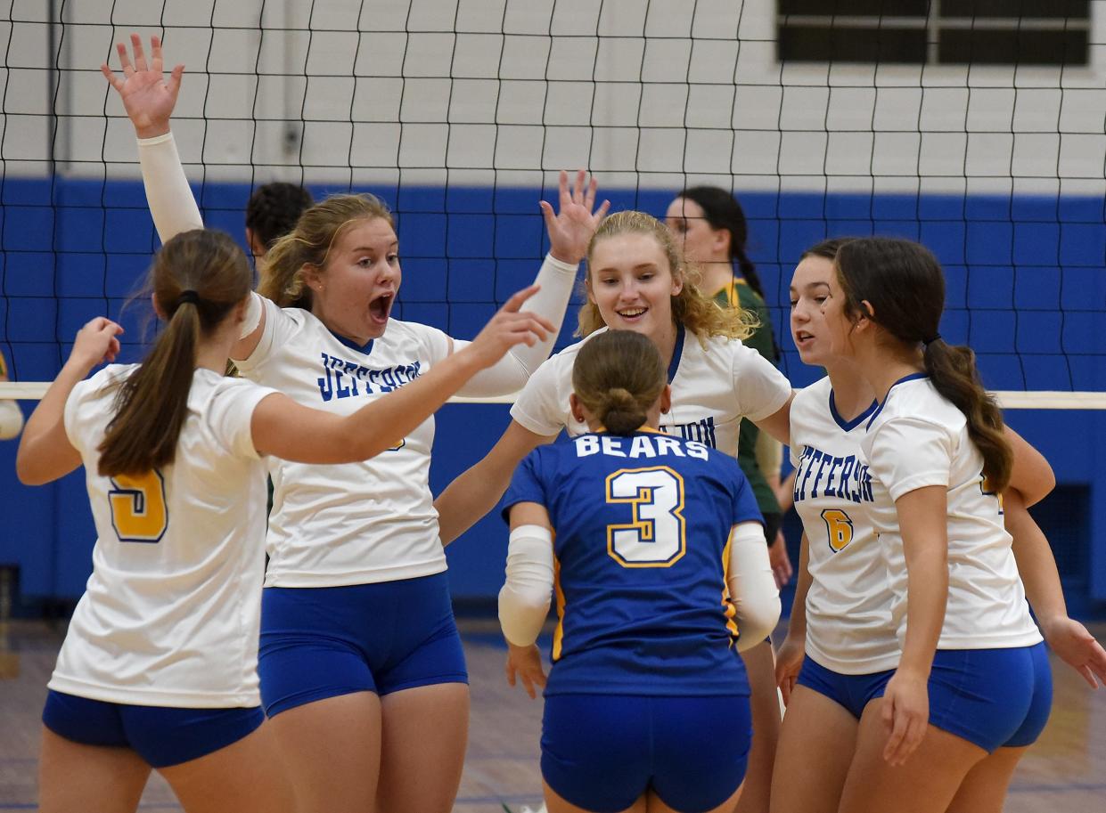 Meagan Middleton of Jefferson celebrates with teammates Anna Boggs, Gracie Jones, Lindsey Gennoe, Jenna Flint, and Clare Boggs after a scoring a point as they battled with Flat Rock for the victory in five sets 25-20, 25-23, 21-25, 22-25, 15-11 Monday, October 9, 2023.