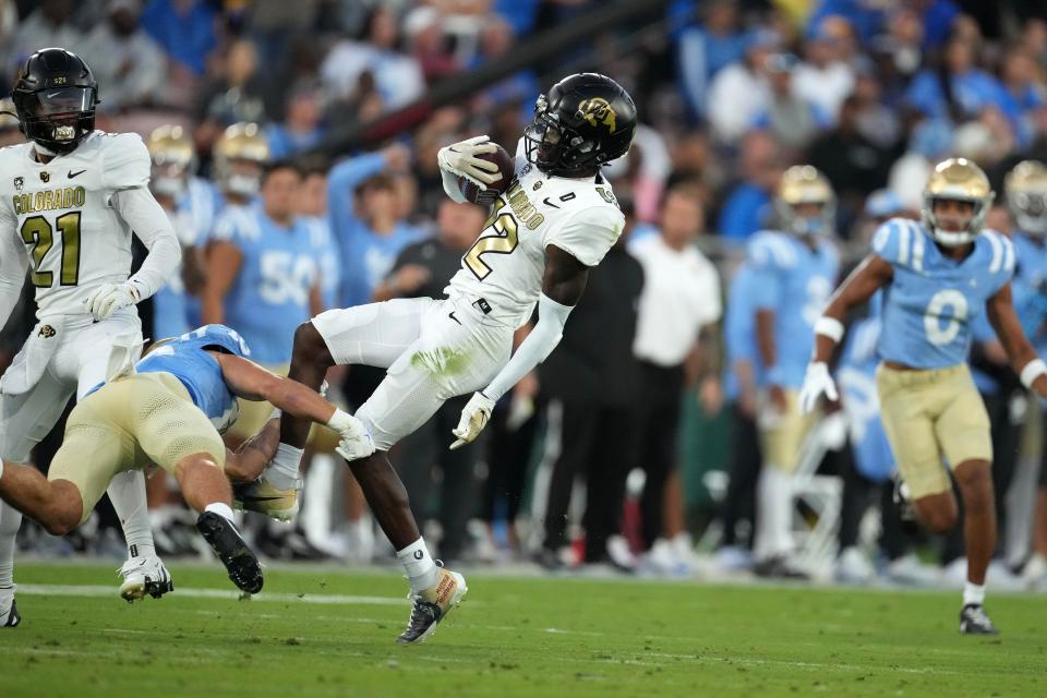 Colorado cornerback Travis Hunter (12) intercepts a pass against UCLA in the first half in the Rose Bowl.