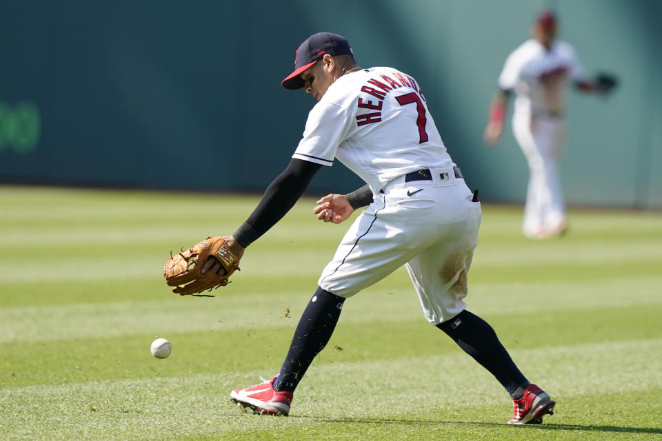 Cleveland Indians' Cesar Hernandez bobbles the ball in the third inning of a baseball game against the Seattle Mariners, Saturday, June 12, 2021, in Cleveland. Ty France was safe at first base. (AP Photo/Tony Dejak)