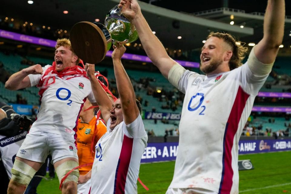 England’s Jamie George, centre, and teammates celebrate with the Ella-Mobbs cup following the third rugby international Mark Baker/AP) (AP)