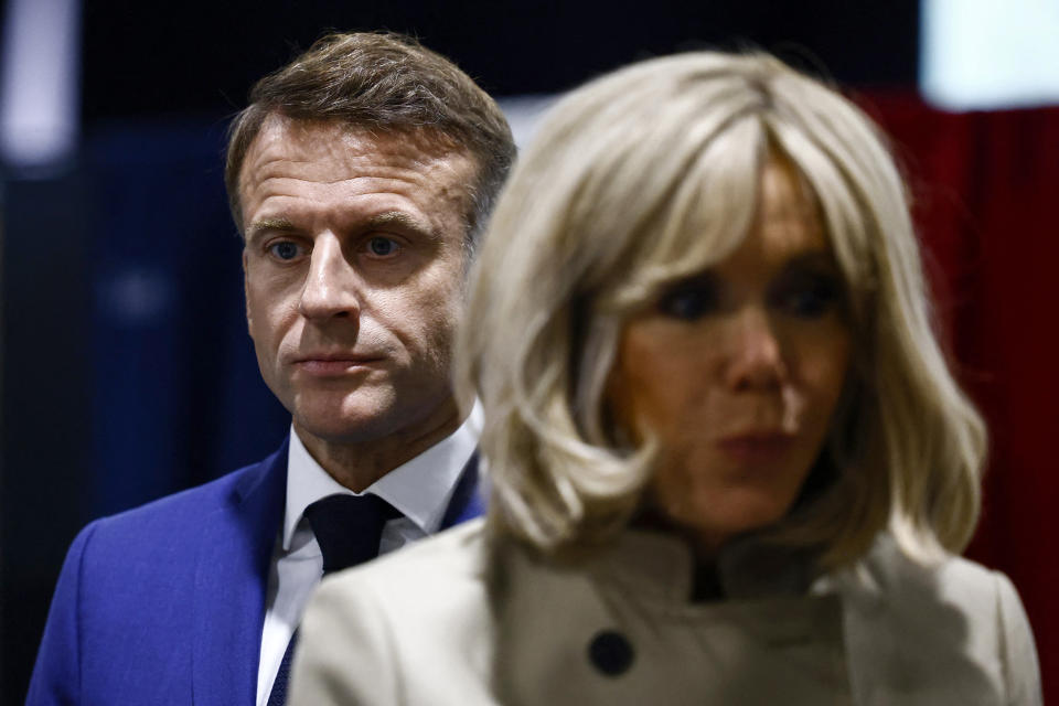 FILE - French President Emmanuel Macron and his wife Brigitte Macron stand in the voting station before voting in Le Touquet-Paris-Plage, northern France, Sunday, June 30, 2024. After France’s far-right National Rally surged into the lead in the first round of legislative elections, some European neighbors are warily eyeing the latest country on the continent to veer to the right. (Yara Nardi, Pool via AP, File)