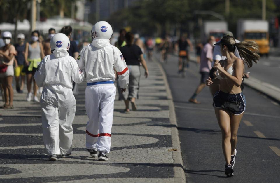 Tercio Galdino, 66, and his wife Aliceia, 65, wear their protective 'space suits' as they walk on the sidewalk of Copacabana Beach amid the outbreak of the coronavirus disease (COVID-19) in Rio de Janeiro, Brazil, July 11, 2020.