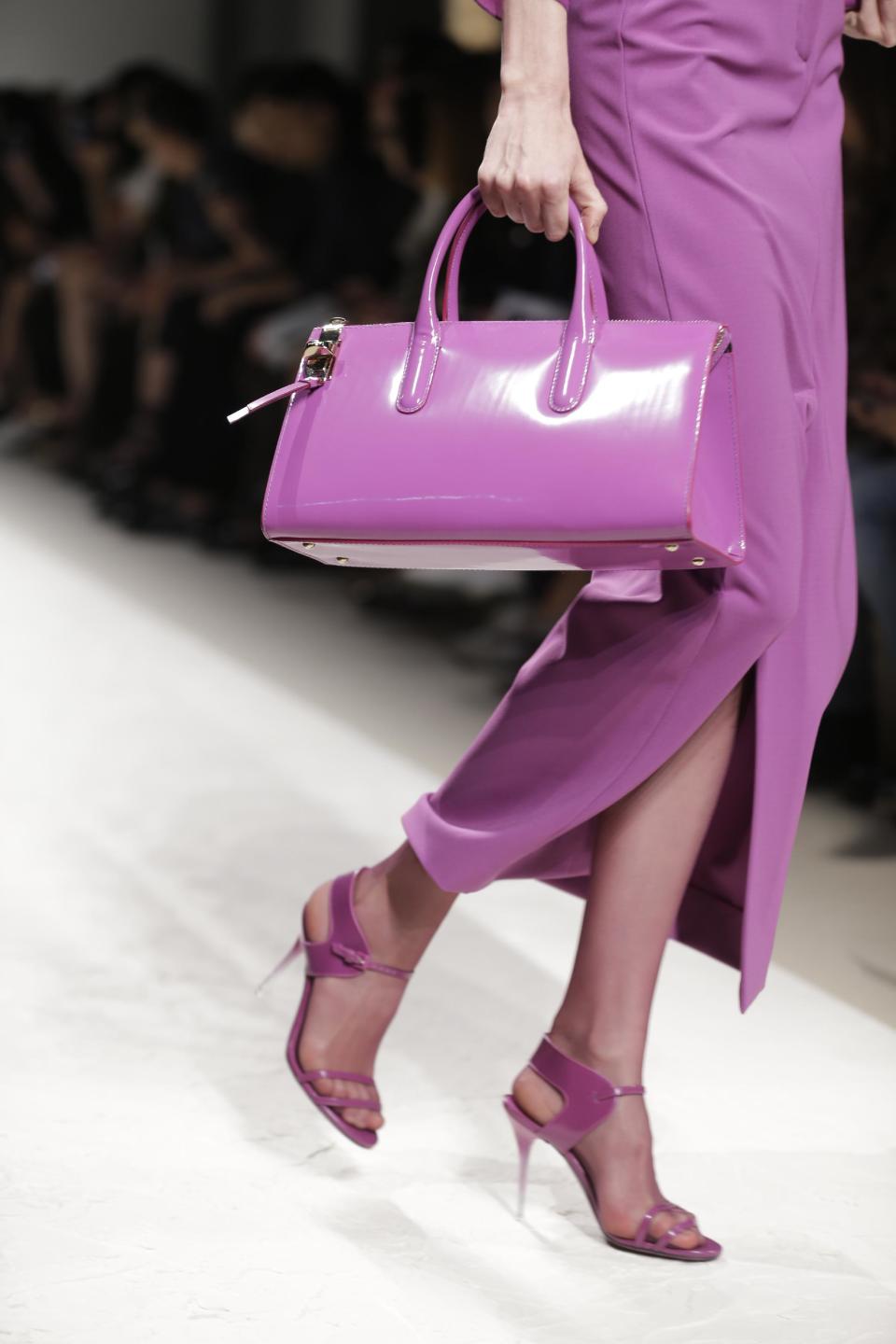 FILE - In this Sept. 19, 2013 file photo, a model wears a creation for Max Mara women's Spring-Summer 2014 collection, part of the Milan Fashion Week, unveiled in Milan, Italy. Orchid is growing on us: A version of the purple hue is Pantone Inc.’s color of the year for 2014. AP Photo/Luca Bruno)