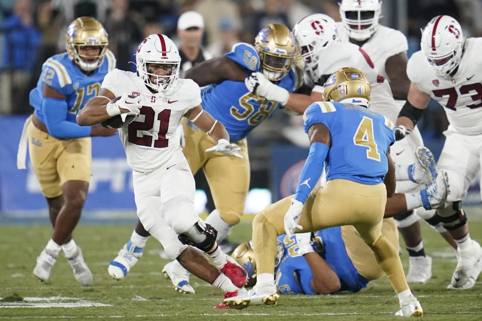 Stanford running back Caleb Robinson (21) runs the ball during the first half of an NCAA college football game against UCLA in Pasadena, Calif., Saturday, Oct. 29, 2022. (AP Photo/Ashley Landis)