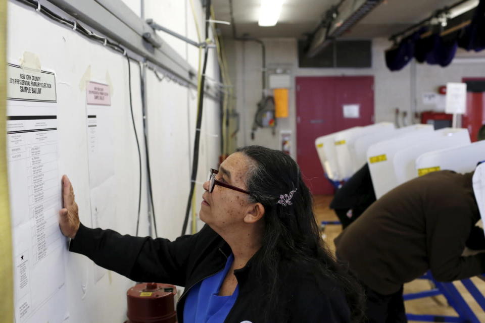 Studying a sample ballot in East Harlem