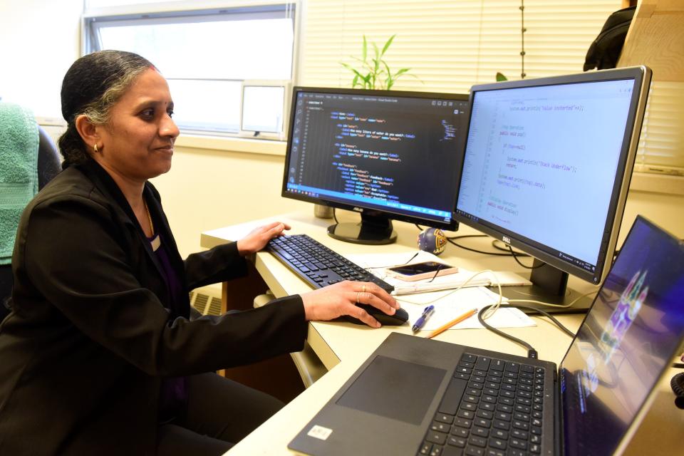 Dr. Selva Shanmugam, a computer science professor, reads a few lines of code in her office at Ashland University.