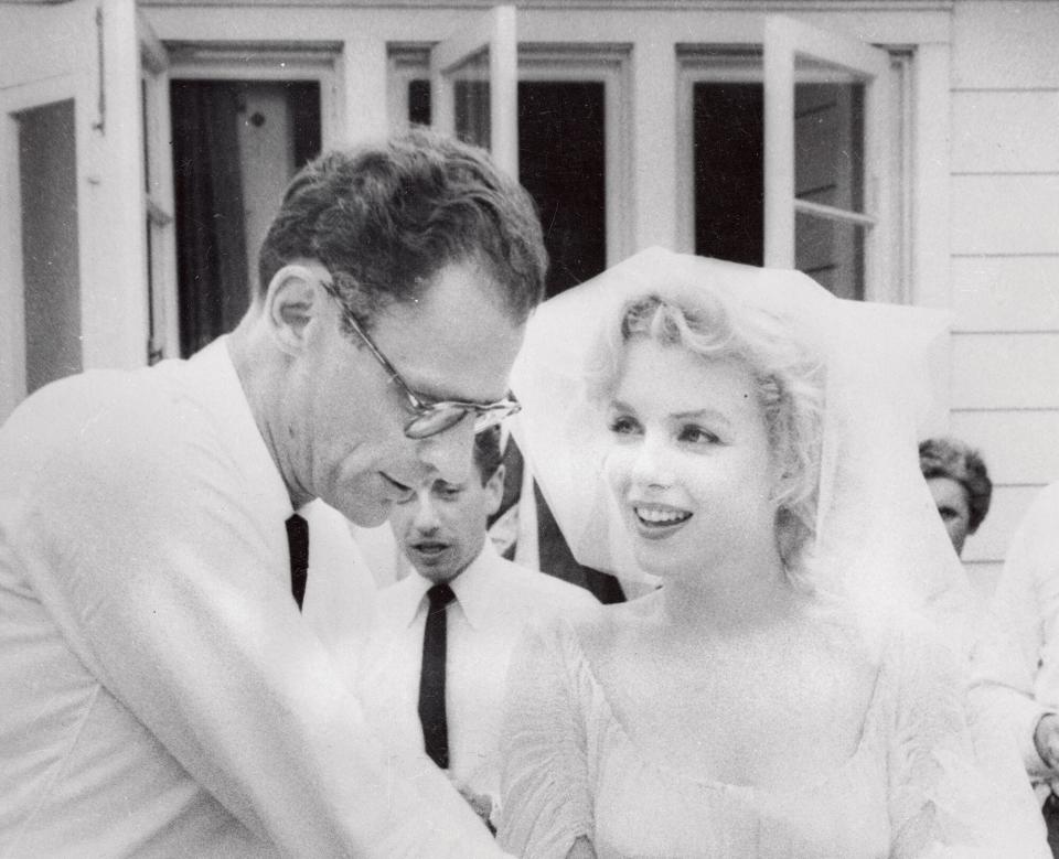 Arthur Miller and his bride, Marilyn Monroe are shown after their marriage in a religious ceremony at the home of Mr.and Mrs.James Barrett of South Salem, NY. Rabbi Robert Goldburg of New Haven and Ha