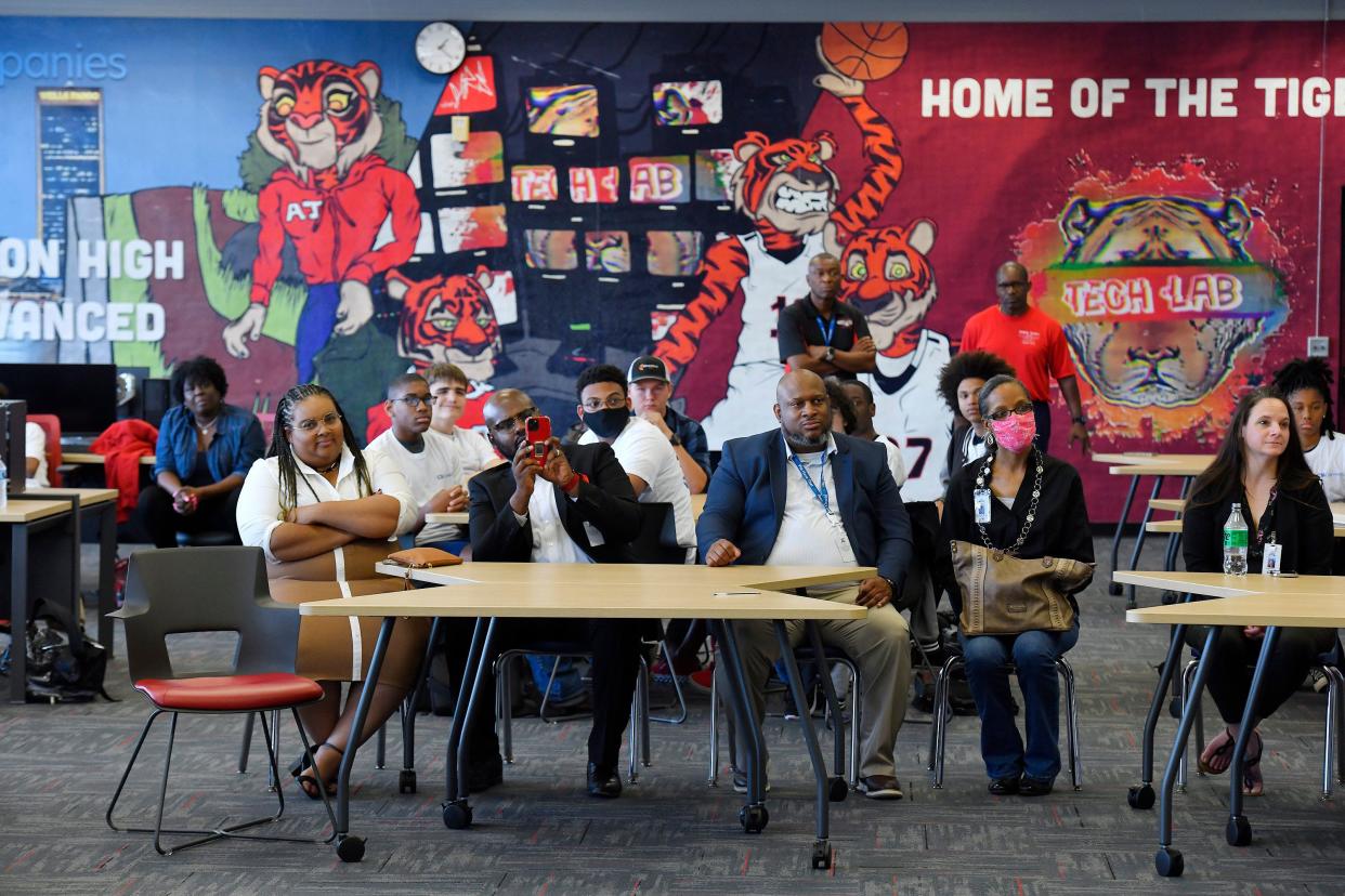 Faculty and students at Andrew Jackson High School listen to speakers at a gathering Friday marking the launch of a "tech lab" in an area remade from an area that had been part of the school's library.