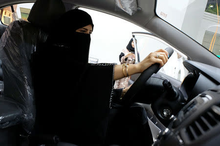 FILE PHOTO: A Saudi woman checks a car at the first automotive showroom solely dedicated for women in Jeddah, Saudi Arabia, Jan. 11, 2018. REUTERS/Reem Baeshen/File Photo