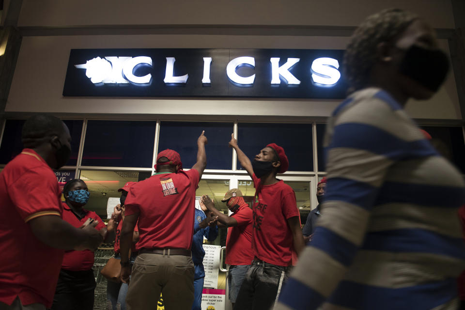 Economic Freedom Fighters (EFF) supporters protest outside a Clicks store in Soweto, Johannesburg, Monday, Sept. 7 2020 calling for the closure of the stores around the country. The chain store posted an advertisement on their website that negatively described natural Black hair labelled as being "Dry and Damaged" and "Frizzy and Dull", while white people's hair was called "Fine and Flat" and "Normal". (AP Photo/Shiraaz Mohamed)