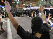 <p>Protesters raise their hands after Phoenix police used pepper spray outside the Phoenix Convention Center, Tuesday, Aug. 22, 2017, in Phoenix. Protests were held against President Trump as he hosted a rally inside the convention center. (AP Photo/Matt York) </p>