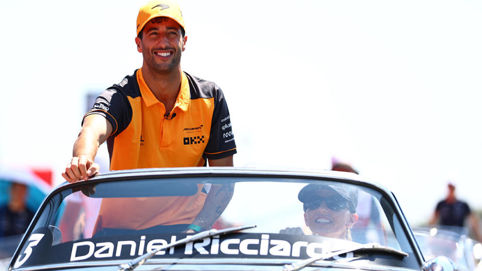 Daniel Ricciardo is driven around in a pre-race parade.
