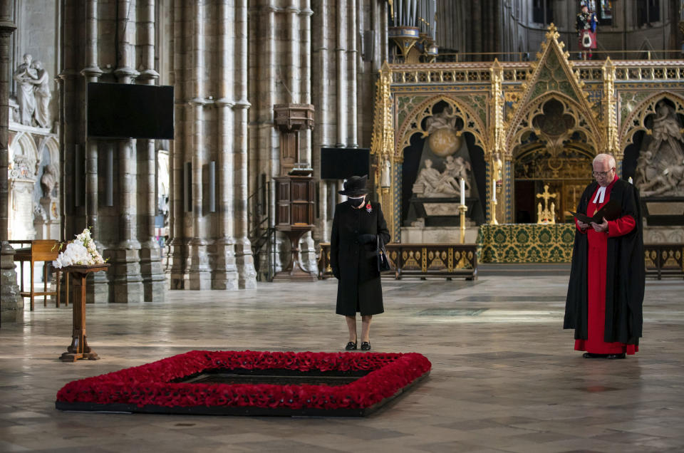 Britain's Queen Elizabeth II, listens as the Dean Of Westminster Abbey David Hoyle reads, during a ceremony to mark the centenary of the burial of the Unknown Warrior, in Westminster Abbey, London, Wednesday, Nov. 4, 2020. Queen Elizabeth II donned a face mask in public for the first time during the coronavirus pandemic when attending a brief ceremony at Westminster Abbey last week to mark the centenary of the burial of the Unknown Warrior. While the 94-year-old has been seen in public on several occasions over the past few months, she has not worn a face covering. (Aaron Chown/Pool Photo via AP)