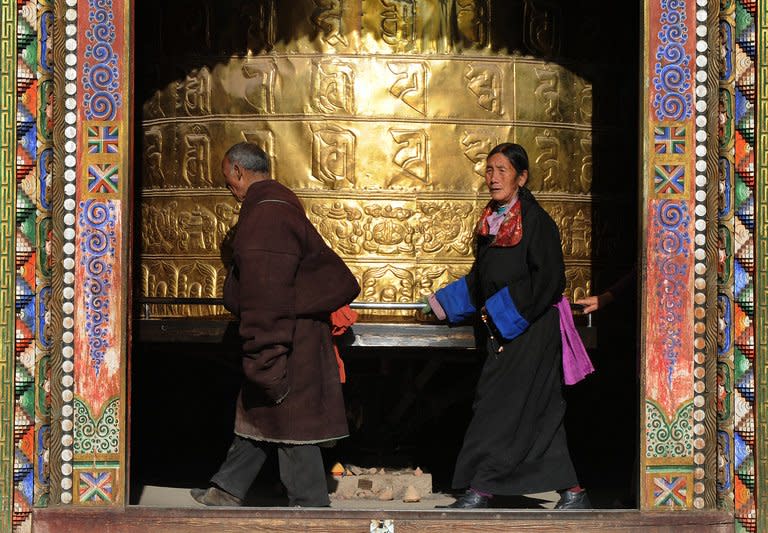 This file photo shows Tibetan pilgrims near a giant prayer wheel at the Rongwu monastery in Tongren, Qinghai Province, pictured on March 17, 2008. A Chinese court in a Tibetan area on Friday convicted a man of intentional homicide and inciting secession for 'goading' a monk to set himself on fire, state media reported, even though the monk did not follow through