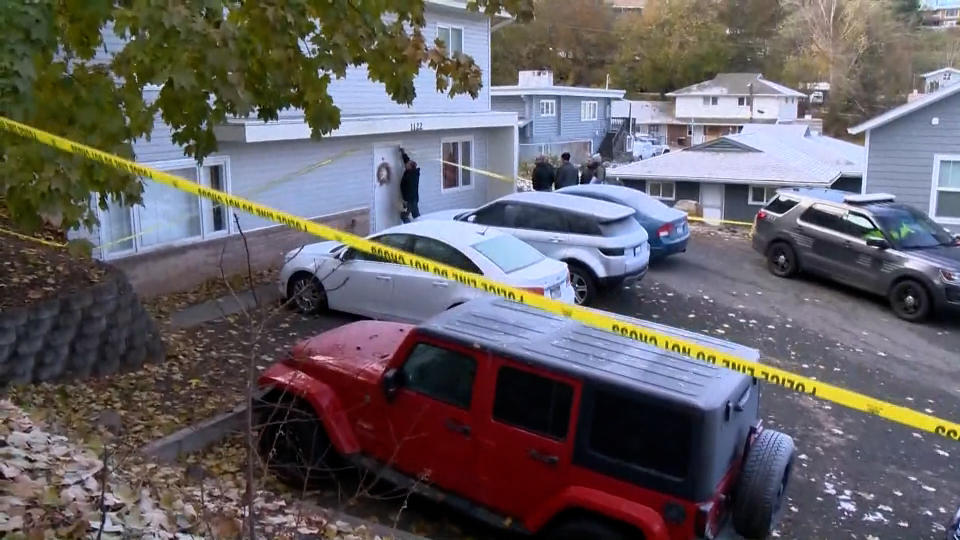 Cars outside a house in a residential neighborhood with yellow caution tape. (NBC News)