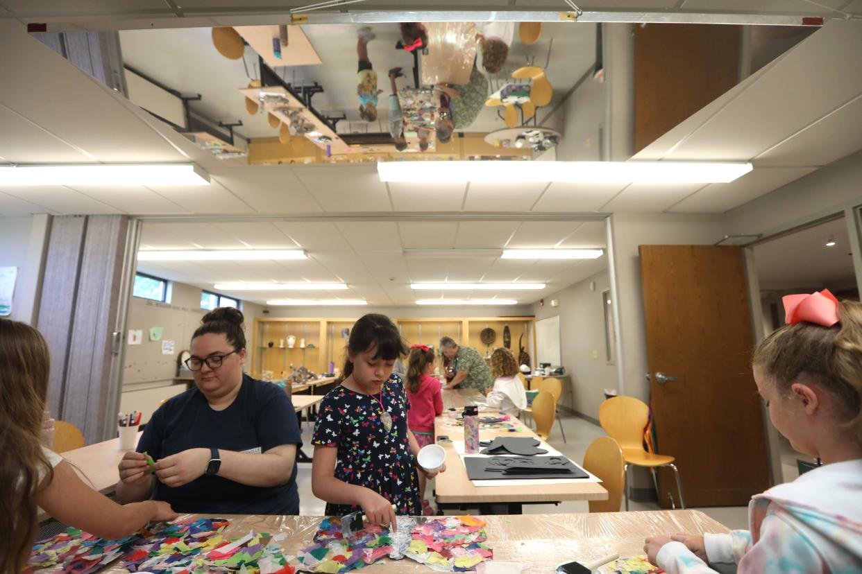 Nora Horstnan, 8, and Zanesville Museum of Art education intern Tiffani Brewster work on butterfly window decorations during the museum's art camp on Friday. The museum will receive $50,000 from the capital budget for EIFS repairs and HVAC replacement.