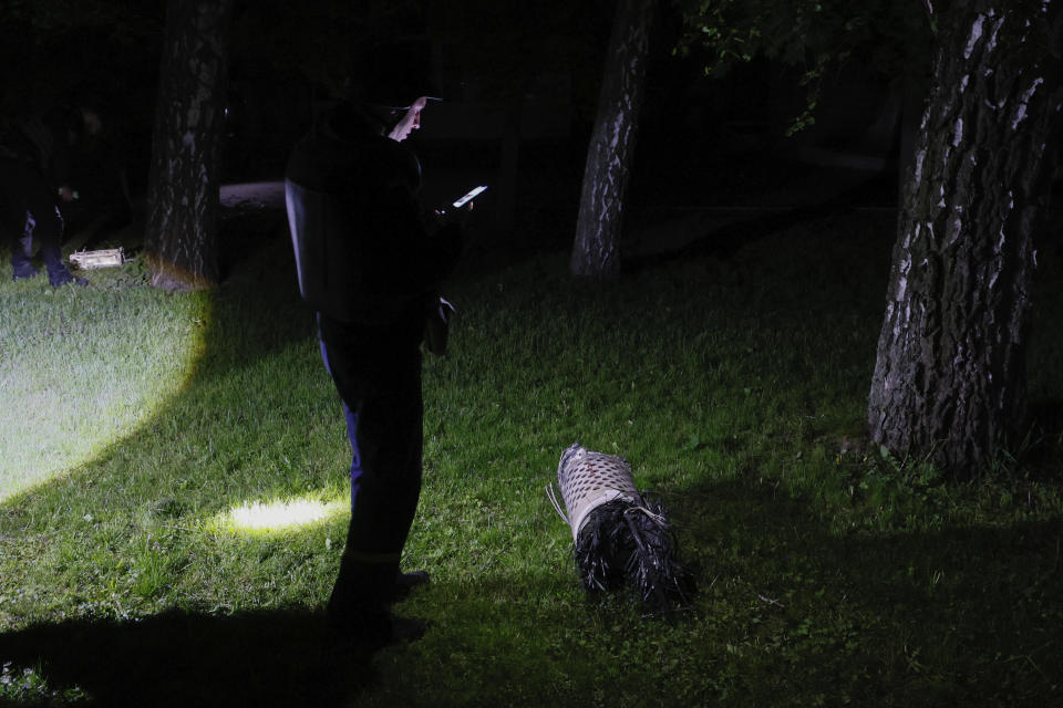 REMOVES ATTRIBUTION THAT THIS WAS A RUSSIAN ROCKET Police officers investigate fragments of a rocket that fell down in a city zoo after it was shot down by air defense system during the night in Kyiv, Ukraine, early Tuesday, May 16, 2023. (AP Photo/Alex Babenko)