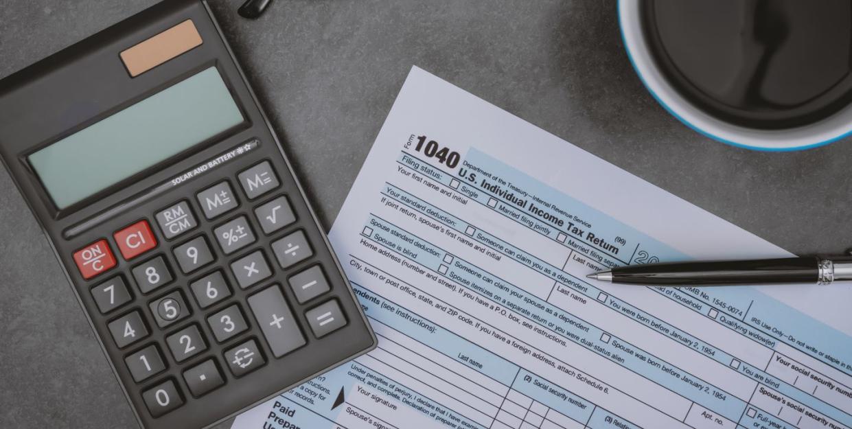 printed tax form on work desk with calculator and pen