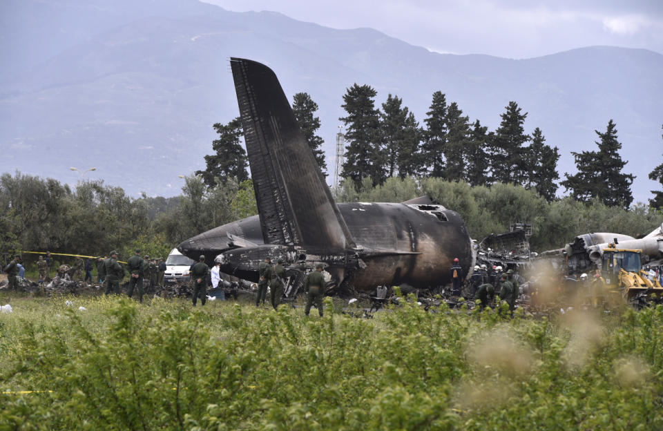 <p>Rescuers are seen around the wreckage of an Algerian army plane which crashed near the Boufarik airbase from where the plane had taken off on April 11, 2018. (Photo: Farouk Batiche/Anadolu Agency/Getty Images) </p>