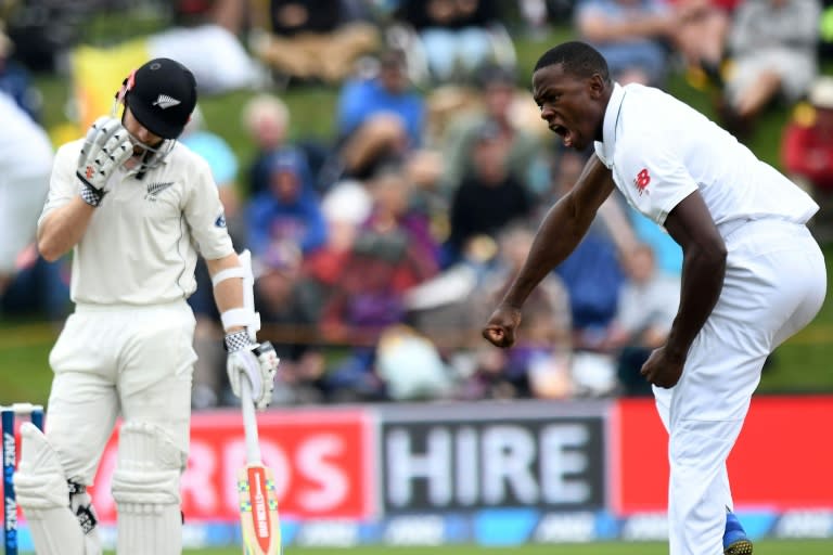 South Africa"s Kagiso Rabada (R) celebrates taking New Zealand captain Kane Williamson's wicket for two