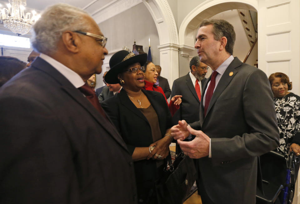 Virginia Gov. Ralph Northam greets, a member of the Richmond 34, Leroy Bray and his wife Cynthia, center, for a breakfast at the Governors Mansion at the Capitol in Richmond, Va., Friday, Feb. 22, 2019. The Richmond 34 were a group of African Americans who defied segregation laws in the 1960's (AP Photo/Steve Helber)