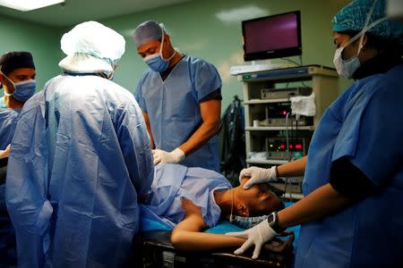 A patient lies on a bed during sterilization surgery in the operating room of a hospital in Caracas, Venezuela July 27, 2016. REUTERS/Carlos Garcia Rawlins