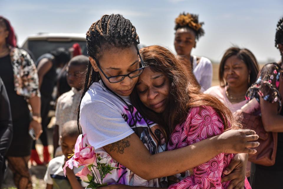 Dominique Green (right), the mother of two-year-old Aubree Green who was killed in last week's deadly tornadoes, is seen at her daughter's burial in Yazoo City on Saturday. Aubree was among the first of the tornadoes' 21 victims to be laid to rest.