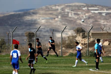 Players from Israeli soccer clubs affiliated with Israel Football Association, Ariel Municipal Soccer Club and Maccabi HaSharon Netanya, play against each other at Ariel Municipal Soccer Club's training grounds in the West Bank Jewish settlement of Ariel September 23, 2016. Picture taken September 23, 2016. REUTERS/Amir Cohen