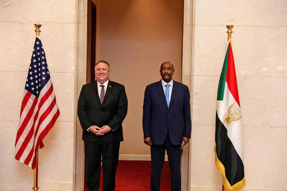 U.S. Secretary of State Mike Pompeo stands with Sudanese Gen. Abdel-Fattah Burhan, the head of the ruling sovereign council, in Khartoum, Sudan, Tuesday, Aug. 25, 2020. Pompeo is the most senior U.S. official to visit the African country since last year’s ouster of its autocratic leader, Omar al-Bashir. Pompeo’s visit Tuesday is meant to discuss the normalization of ties between Sudan and Israel and also show U.S. support for the country’s fragile transition to democracy. (Sudanese Cabinet via AP)