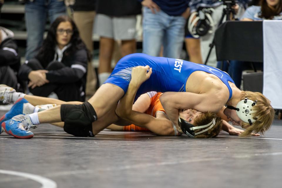 Waukee Northwest's Carter Freeman, top, won the Council Bluffs Wrestling Classic on Saturday at the Mid-America Center. Freeman went 6-0 and won at 126 pounds.