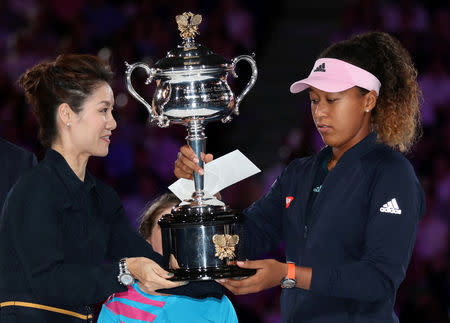 Tennis - Australian Open - Women's Singles Final - Melbourne Park, Melbourne, Australia, January 26, 2019. Japan's Naomi Osaka receives the trophy after winning the final against Czech Republic's Petra Kvitova. REUTERS/Lucy Nicholson