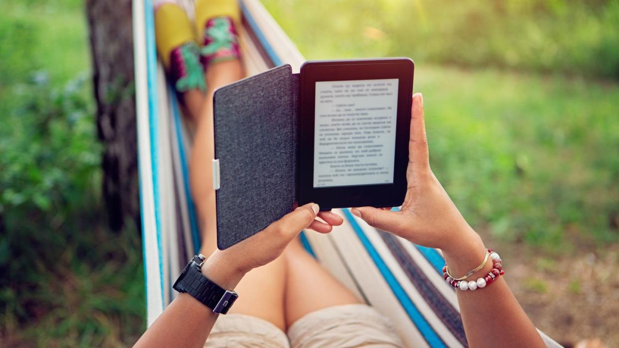 person reading ebook in a hammock