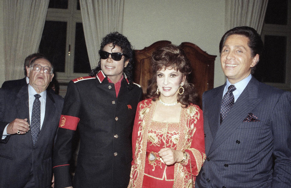 FILE - U.S. pop superstar Michael Jackson poses with Italian actress Gina Lollobrigida and fashion designer Valentino at a party to honor him at the American Embassy in Rome, Thursday, May 19, 1988.Lollobrigida has died in Rome at age 95. Italian news agency Lapresse reported Lollobrigida’s death on Monday, Jan. 16, 2023 quoting Tuscany Gov. Eugenio Giani. (AP Photo/Gianni Foggia, FIle)
