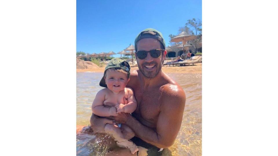 Jamie redknapp holding raphael in the sea 