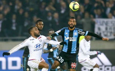 Football Soccer - Olympique Lyon v Olympique Marseille - French Ligue 1 - Grand Stade stadium, Decines, France - 24/1/2016 Olympique Lyon's Alexandre Lacazette (L) in action against Olympique Marseille's Jacques Romao (R) REUTERS/Robert Pratta