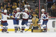 Colorado Avalanche right wings Mikko Rantanen (96) and Valeri Nichushkin (13) celebrate while Vegas Golden Knights goaltender Adin Hill (33) reacts after Rantanen's goal during the second period of an NHL hockey game Sunday, April 14, 2024, in Las Vegas. (AP Photo/Ian Maule)