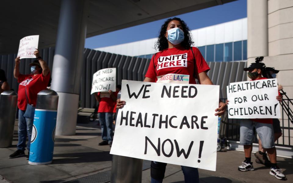 People join a protest for airport workers to call for the need to extend healthcare for laid-off airport workers, amid the global outbreak of the coronavirus disease (COVID-19), in Los Angeles - Reuters