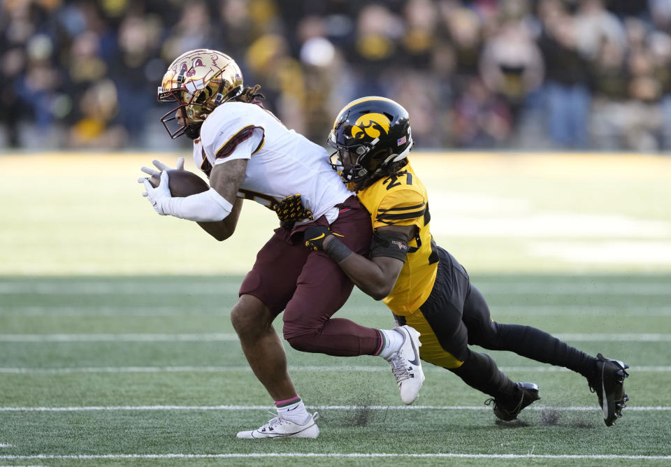 Minnesota wide receiver Daniel Jackson, left, brings in a reception as Iowa defensive back Jermari Harris (27) makes a tackle during the second half of an NCAA college football game, Saturday, Oct. 21, 2023, in Iowa City, Iowa. (AP Photo/Matthew Putney)