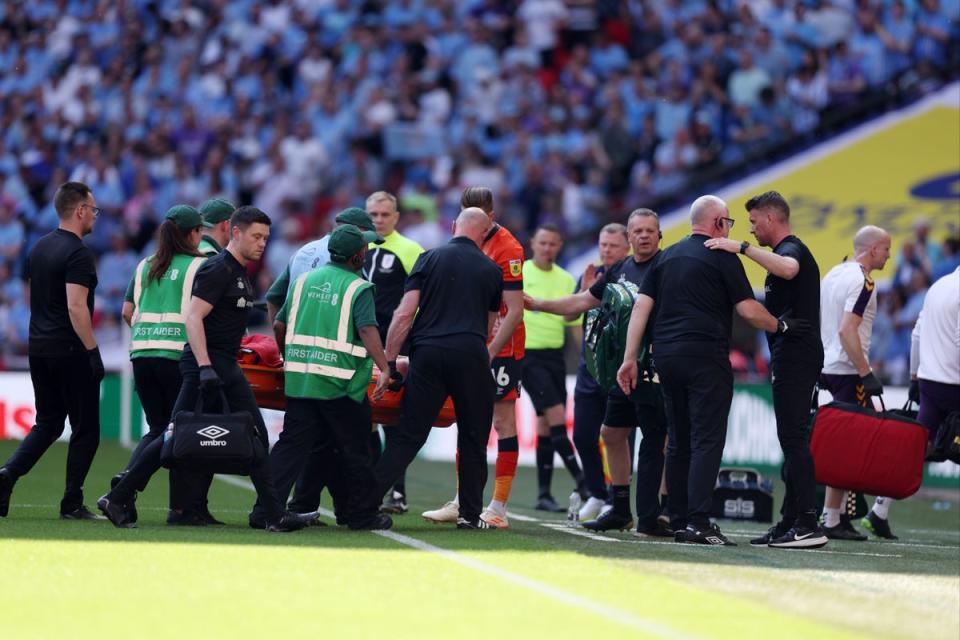 Tom Lockyer was stretchered off after collapsing at Wembley  (Getty Images)