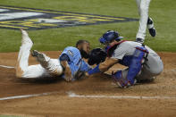 Tampa Bay Rays' Manuel Margot is tagged out at home by Los Angeles Dodgers catcher Austin Barnes trying to steal during the fourth inning in Game 5 of the baseball World Series Sunday, Oct. 25, 2020, in Arlington, Texas. (AP Photo/Tony Gutierrez)